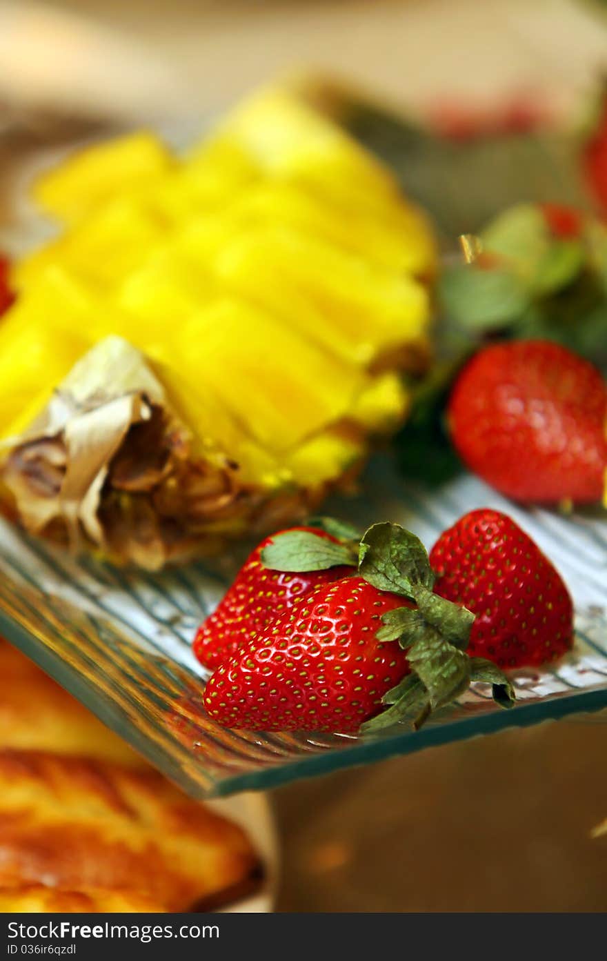 Strawberry and pineapple on the fruit plate