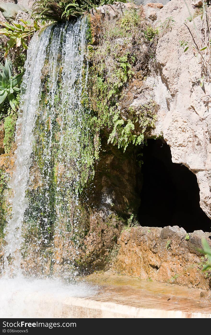 Waterfall and grotto in the Genoves park of Cadiz