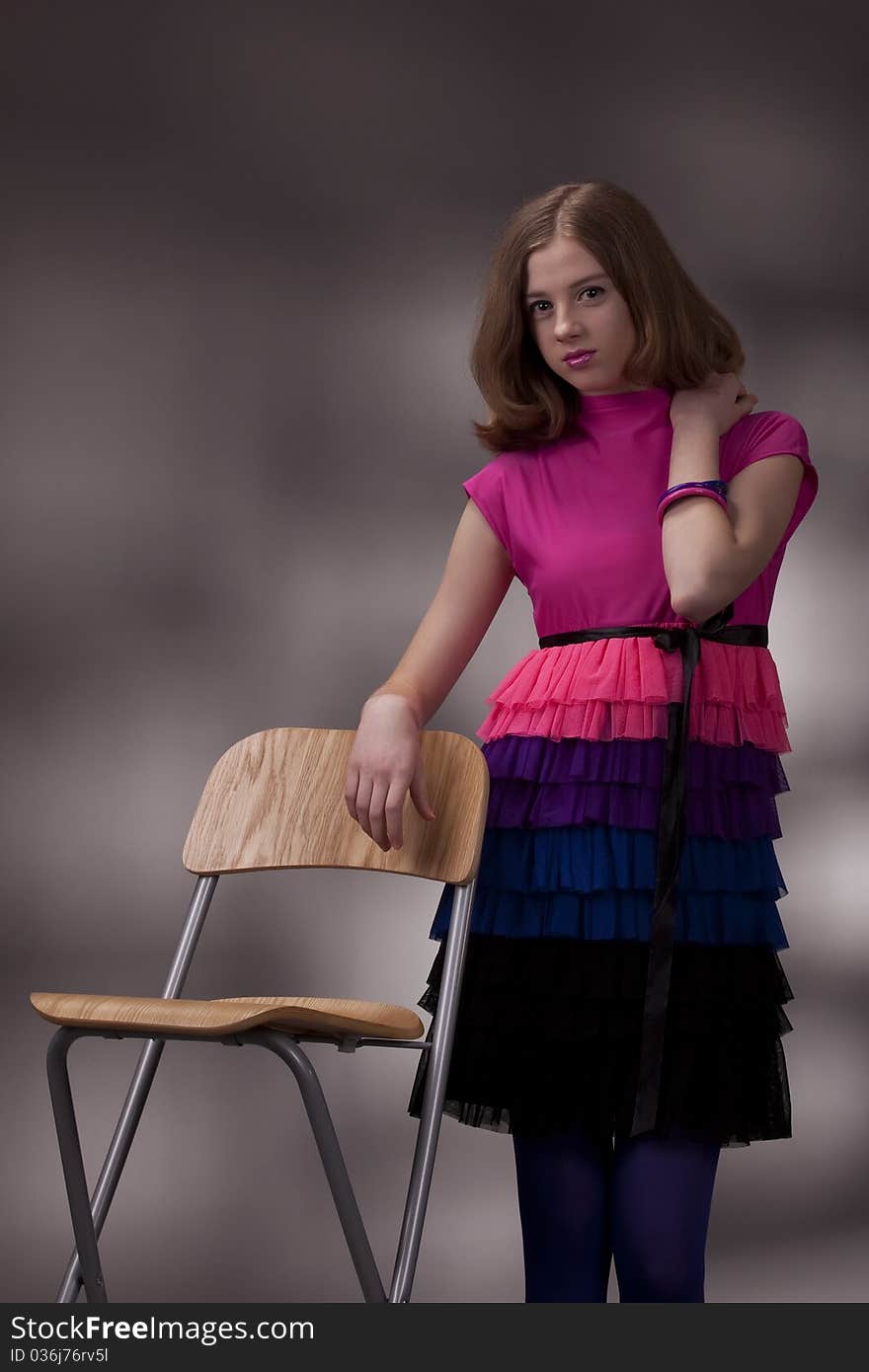 Portrait of the brunette teenage girl on a high chair. Portrait of the brunette teenage girl on a high chair