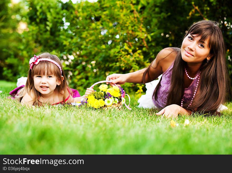 Mother and little girl on the grass