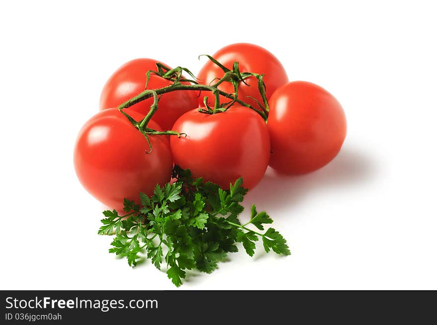 Red tomatoes with parsley isolated on a white background