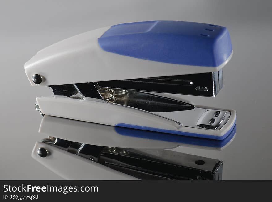 Stapler on a reflective metal