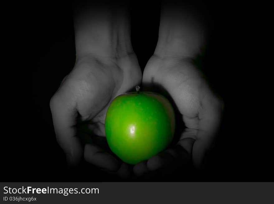 Hand holding the green apple