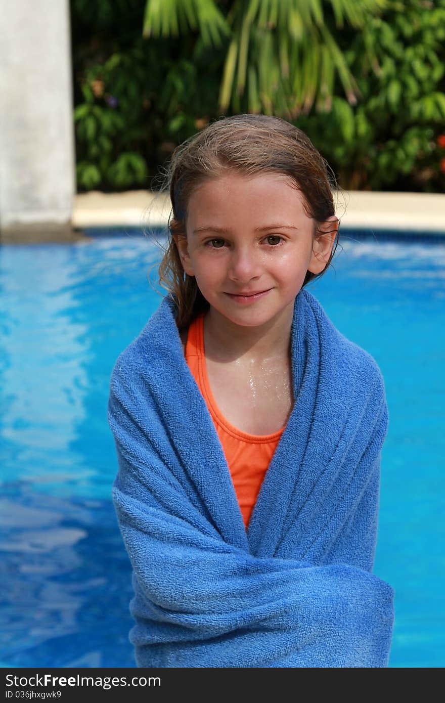 Young girl wrapped in a towel after her swim. Young girl wrapped in a towel after her swim