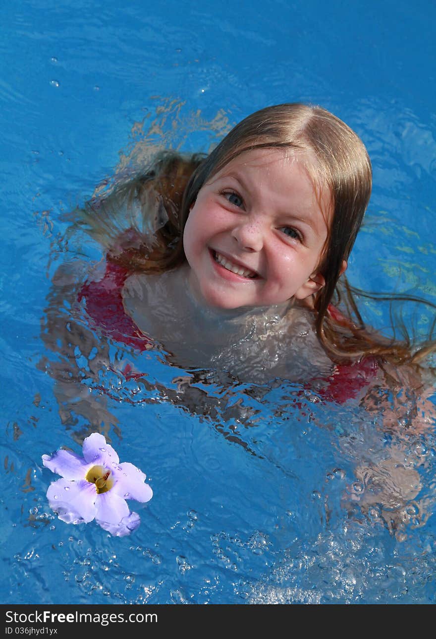 Happy child swimming with flower. Happy child swimming with flower