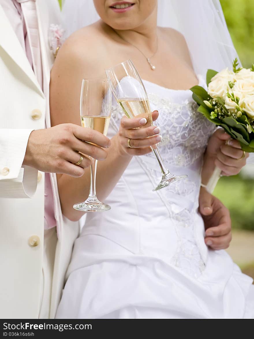 Bride and fiance clink glasses with glasses