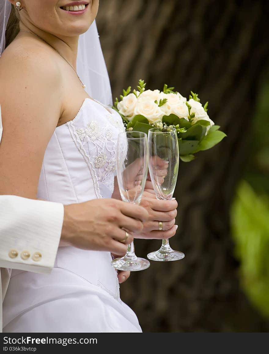 Bride and fiance are holding empty glass. Bride and fiance are holding empty glass