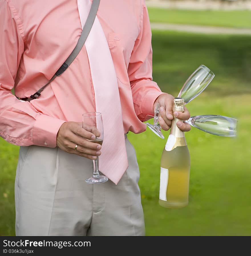 Man with champagne and glasses is ready to take a part in celebration. Man with champagne and glasses is ready to take a part in celebration