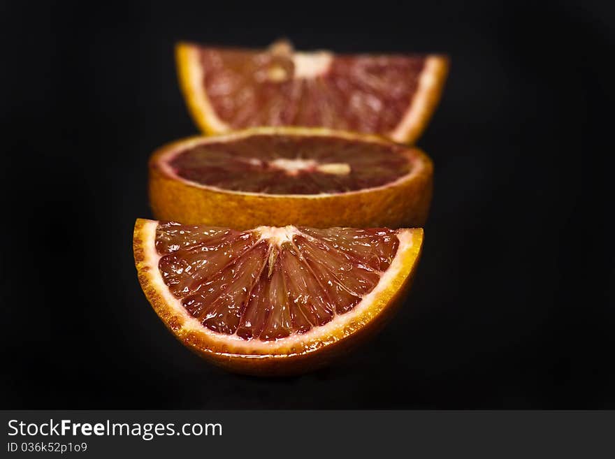 Orange slice shot in the studio isolated on black. Orange slice shot in the studio isolated on black