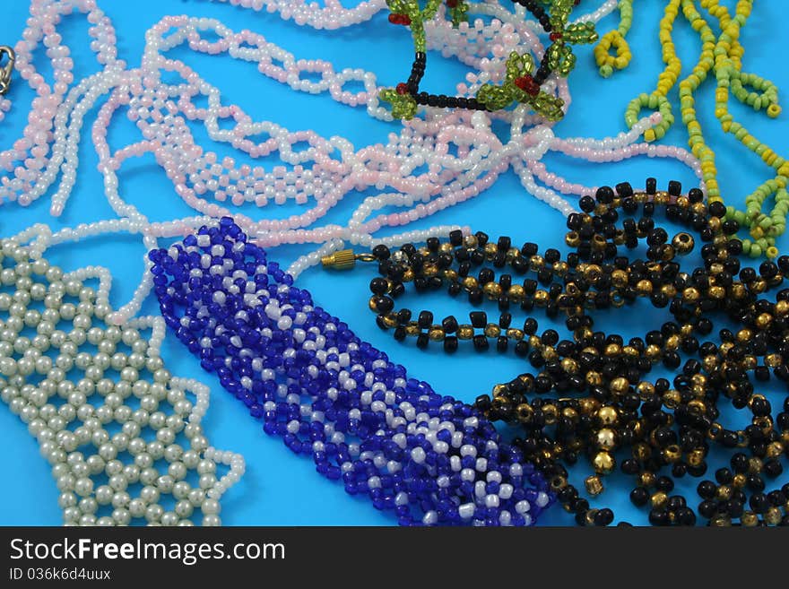 Homemade products from beads on a blue background. Homemade products from beads on a blue background