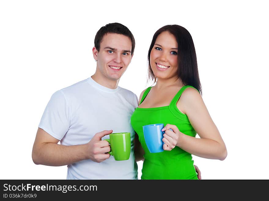 Young couple with a cups of tea over white background