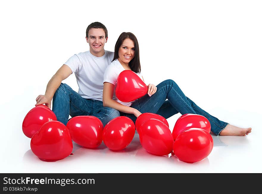 Young couple with a hearts over white background