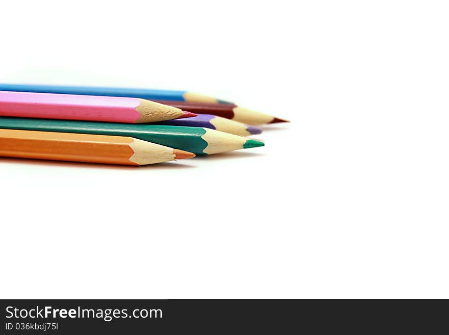 Pencil crayons sharpened points on the white background. Pencil crayons sharpened points on the white background