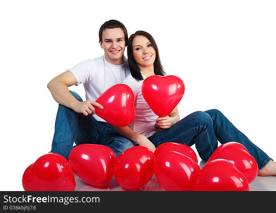 Young couple with a hearts over white background