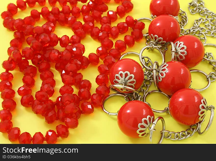 Red beads on a yellow background. Red beads on a yellow background