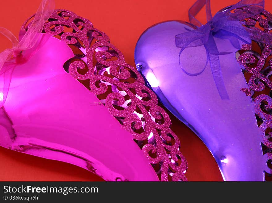 Pink and purple hearts on a red background