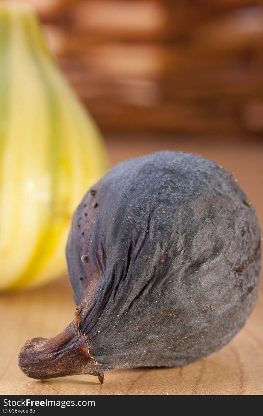 Ripe fruits of a fig on a wooden table.