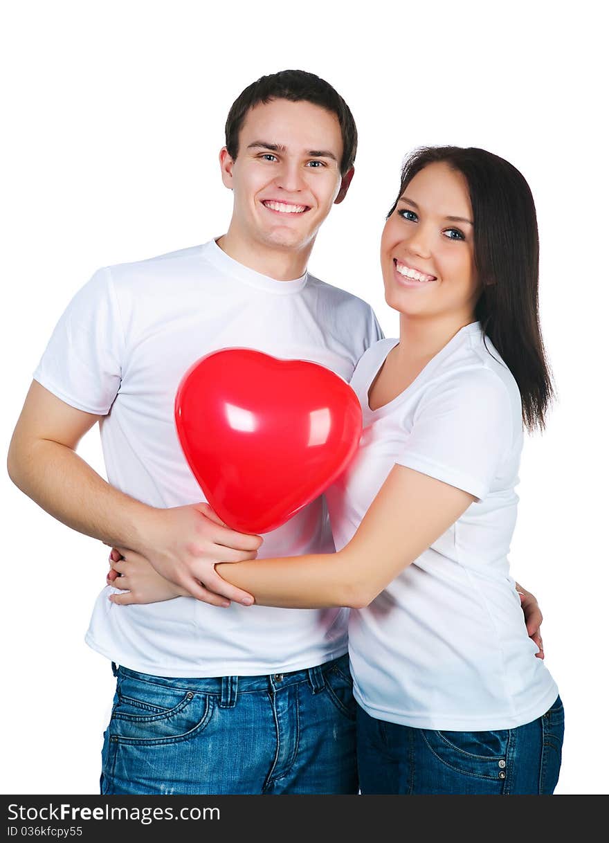 Young couple with a heart over white background