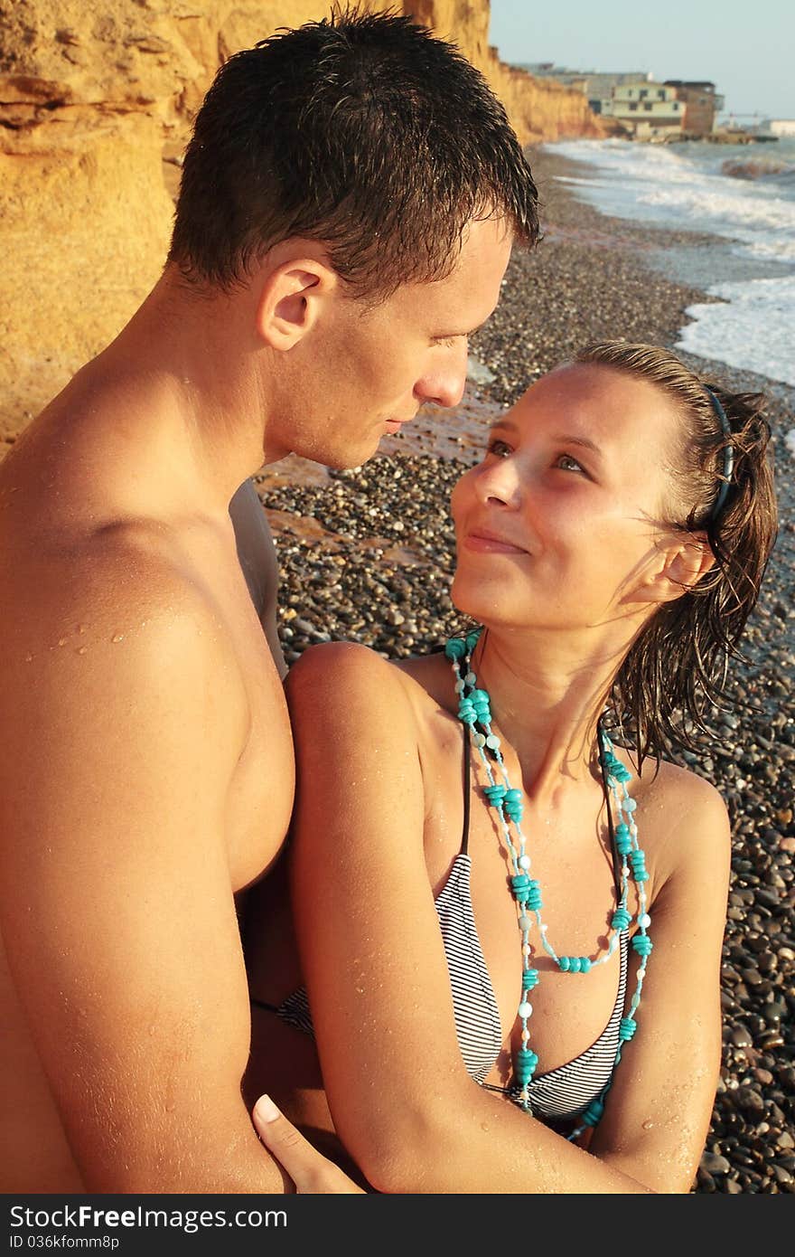 Beautiful young pair on the shore of the sea