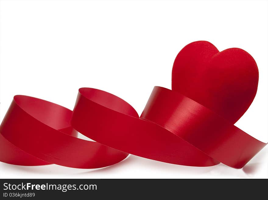 Ribbon and red heart on a white background. Ribbon and red heart on a white background.