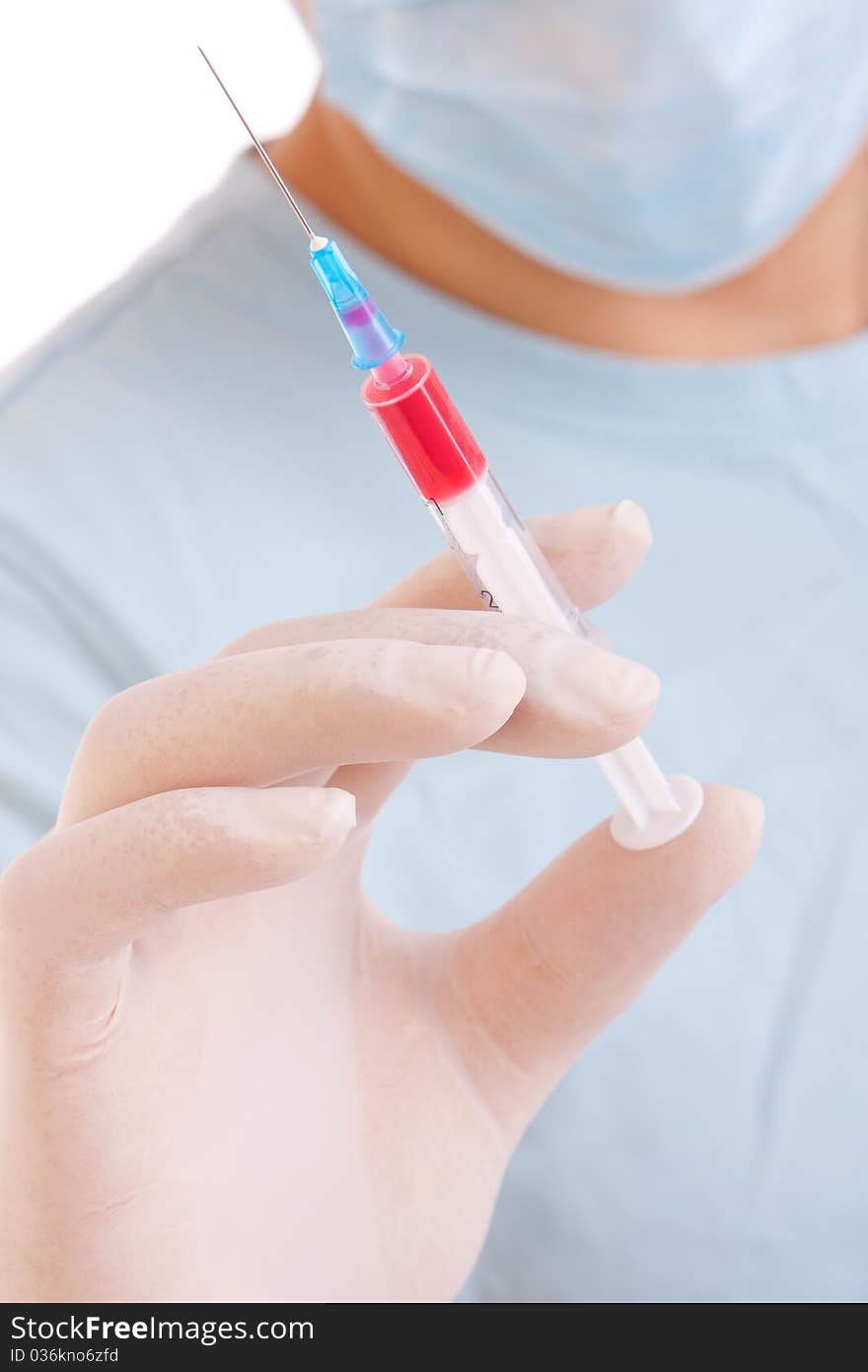 Professional doctor with medical syringe in hands, getting ready for injection