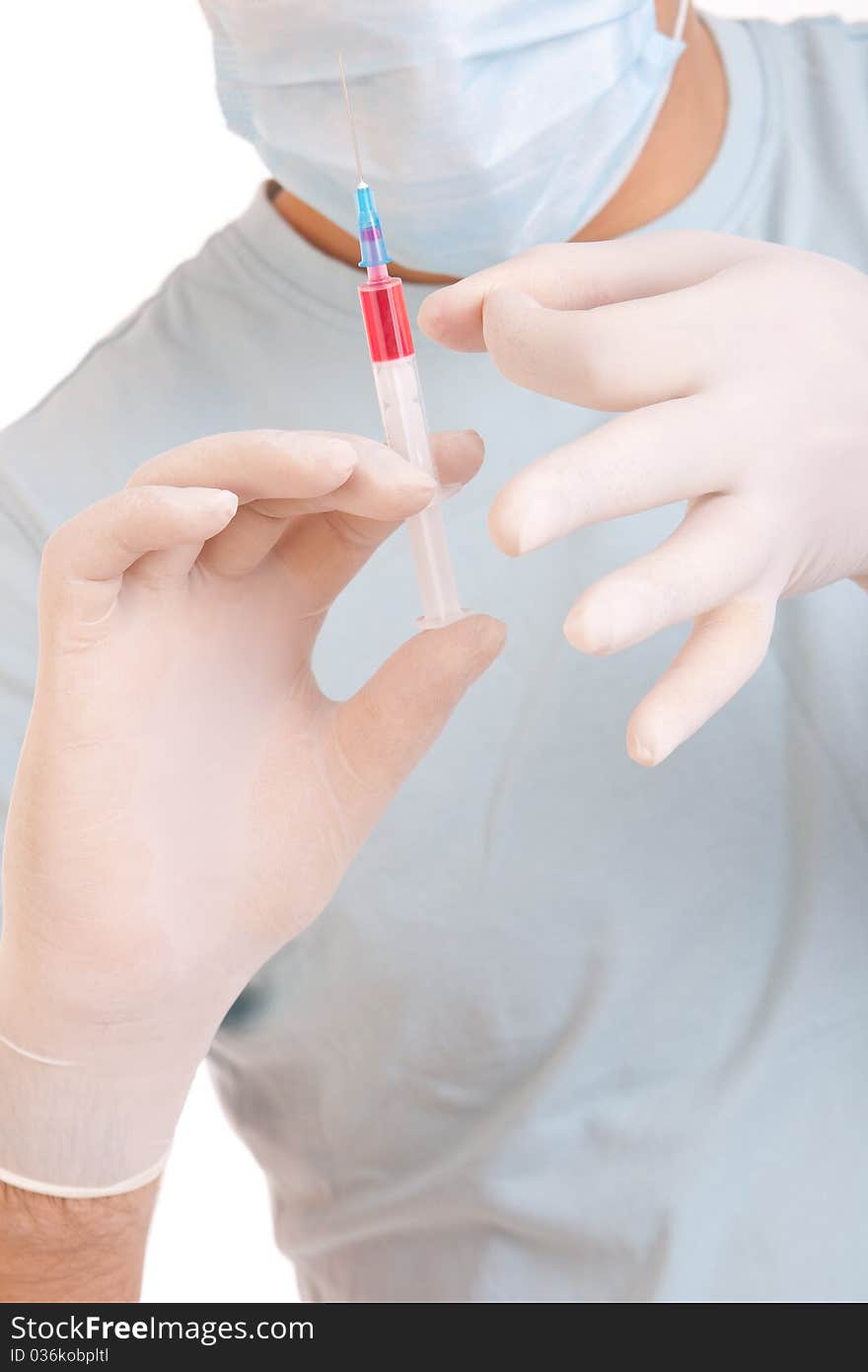 Professional doctor with medical syringe in hands, getting ready for injection