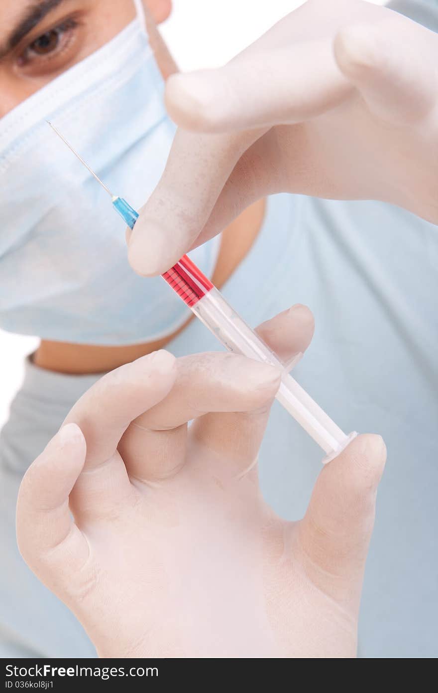 Professional doctor with medical syringe in hands, getting ready for injection