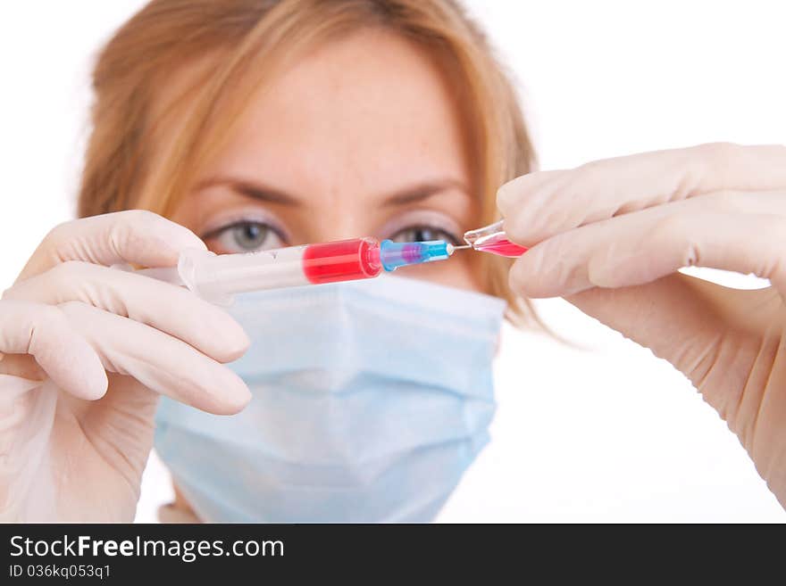 Professional doctor with medical syringe in hands, getting ready for injection