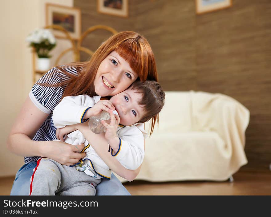 Mother playing with her little son at home on the floor. Mother playing with her little son at home on the floor