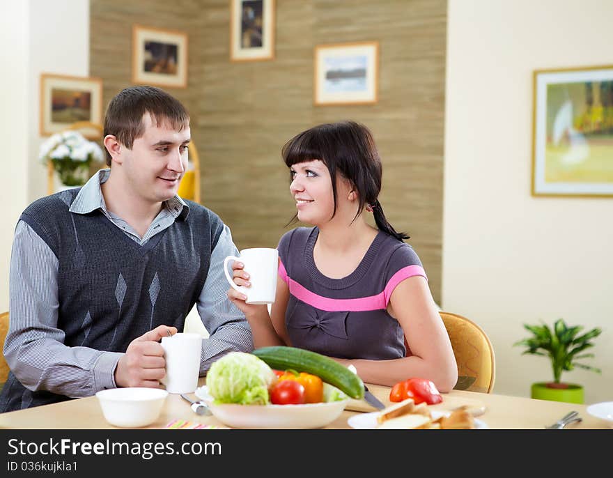 Young couple in love at home eating together and having fun. Young couple in love at home eating together and having fun