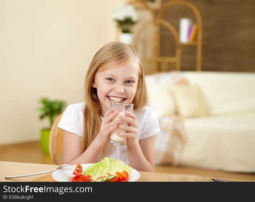 Little girl having meal at home