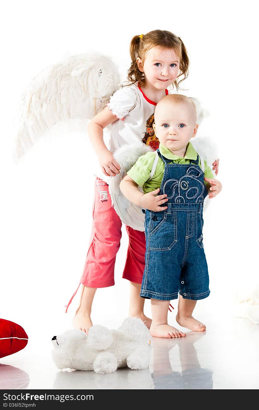 Brother and sister in angel wings isolated on white