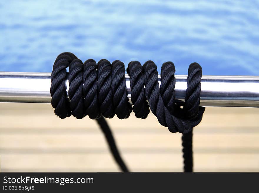 Black sailing rope wired on the metal pipe