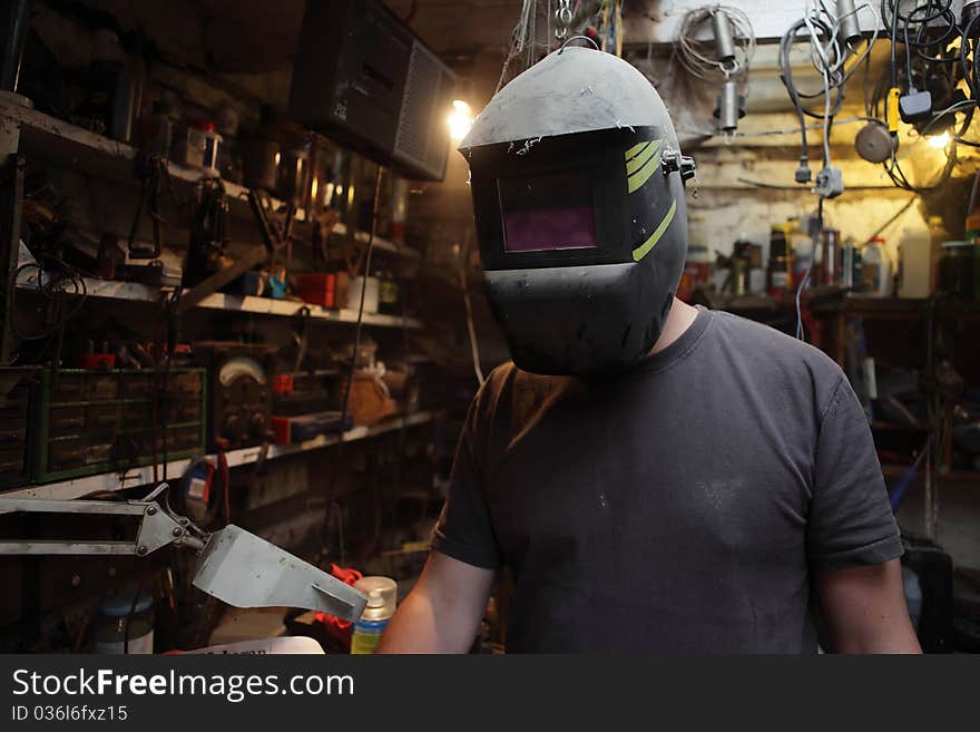 Welder working in an old workshop