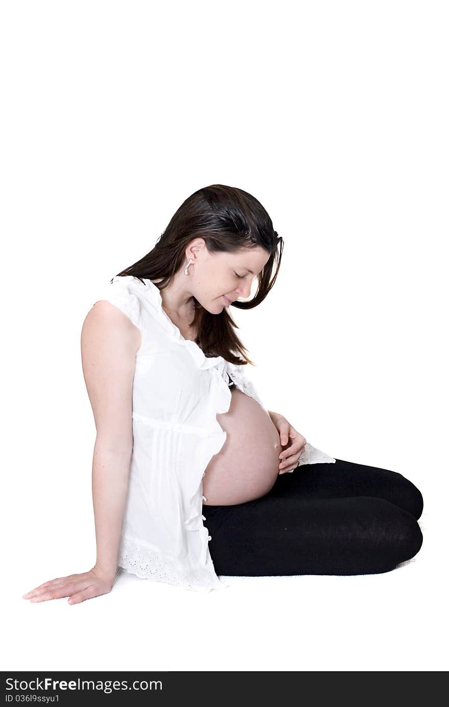 Young pregnant woman on white background