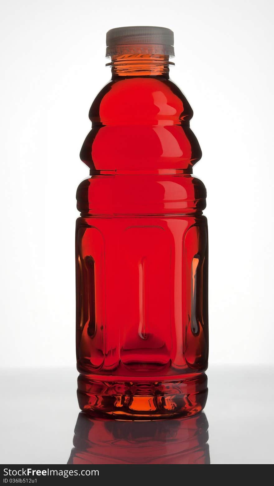 Plastic bottle with blackcurrant juice on white background