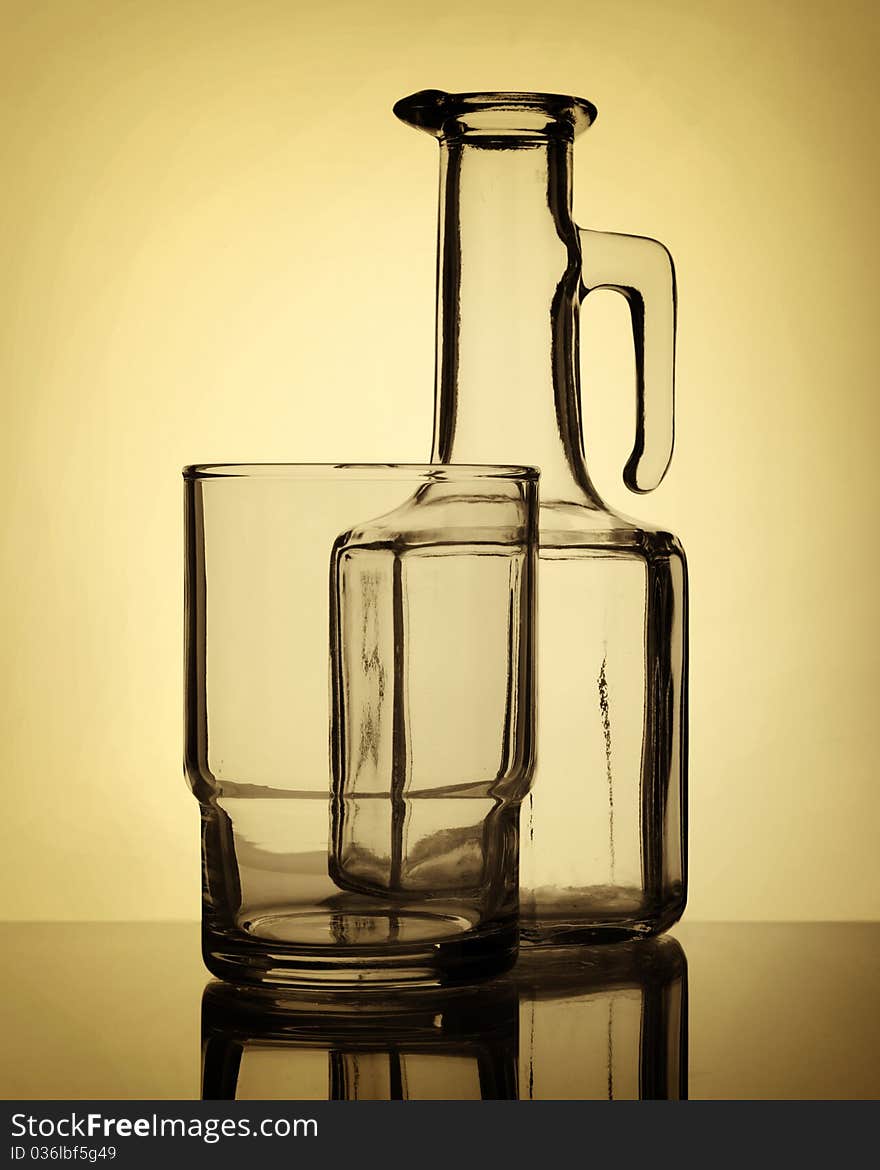 Empty glass and old stile bottle, still life, sepia