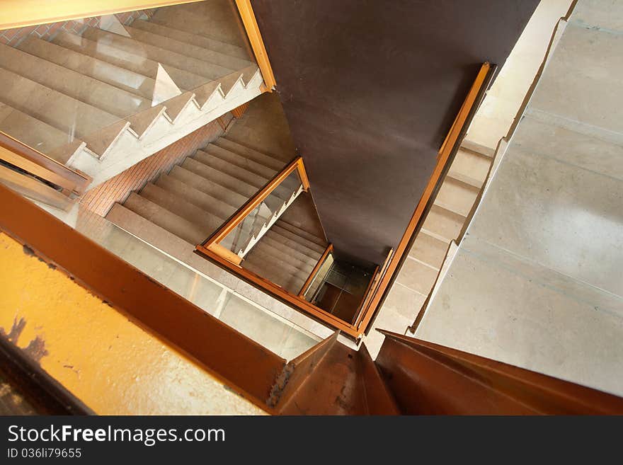 Interior of a building, view on stairs and big brown wall. Interior of a building, view on stairs and big brown wall.