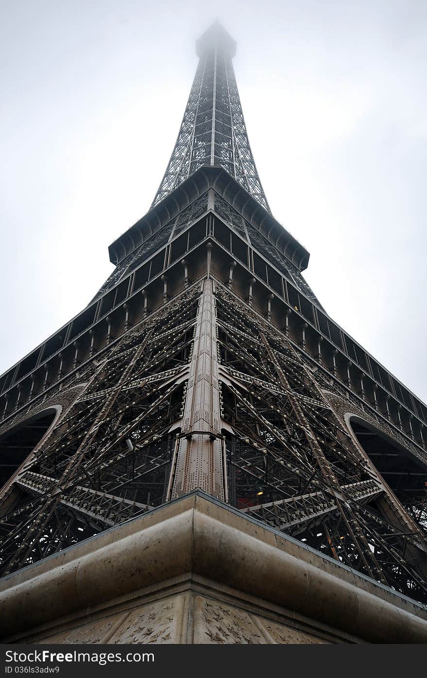 Eiffel tower with mist surrounding the top level