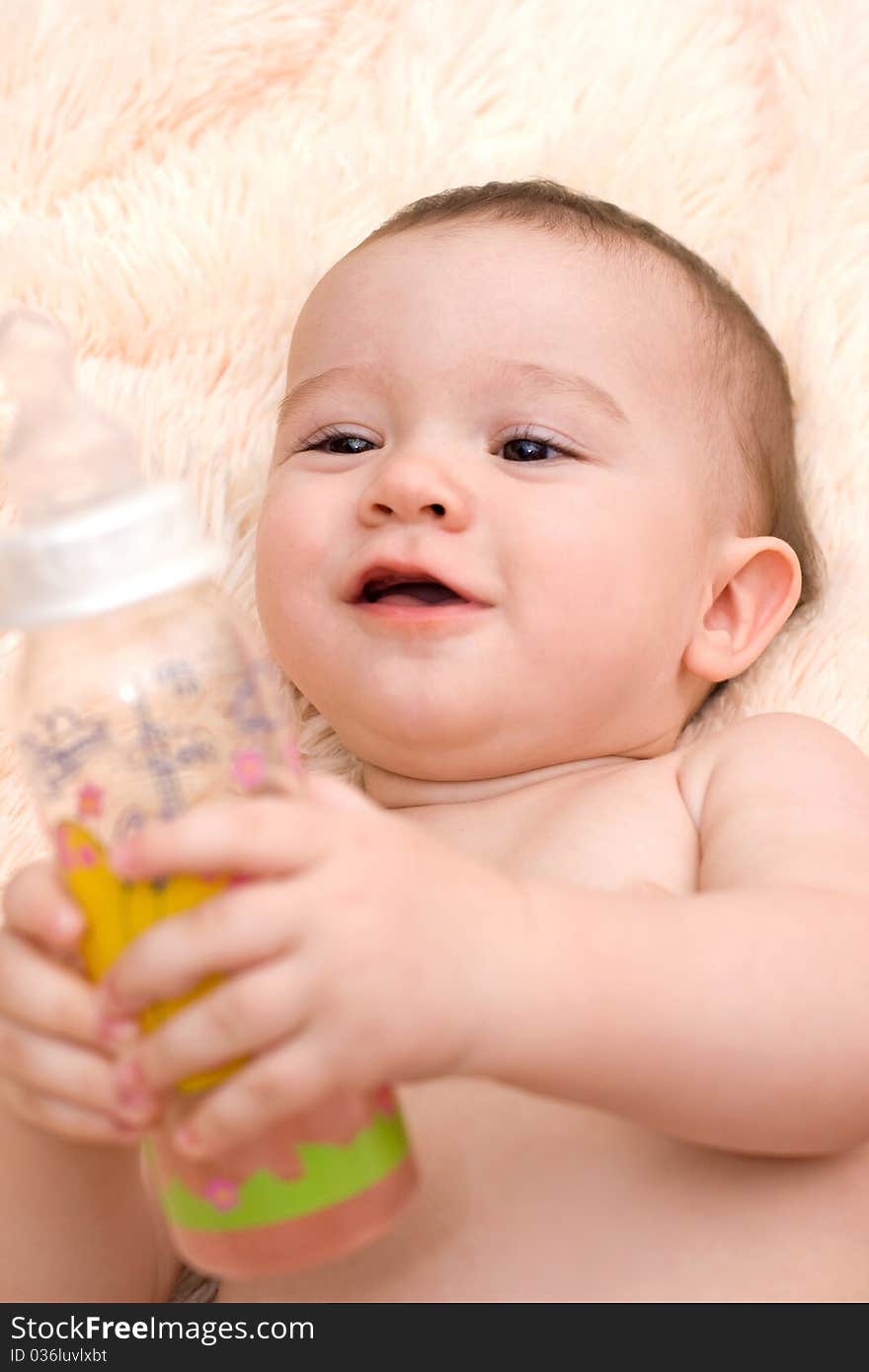 Little Caucasian Boy Drinking From The Bottle