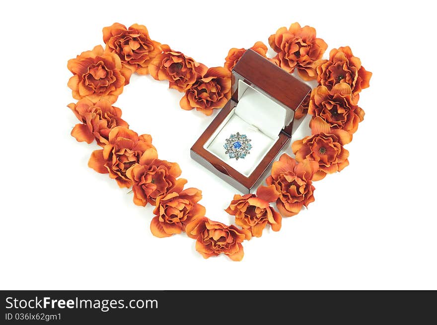 Beautiful ring in wooden box and heart from flowers. Beautiful ring in wooden box and heart from flowers