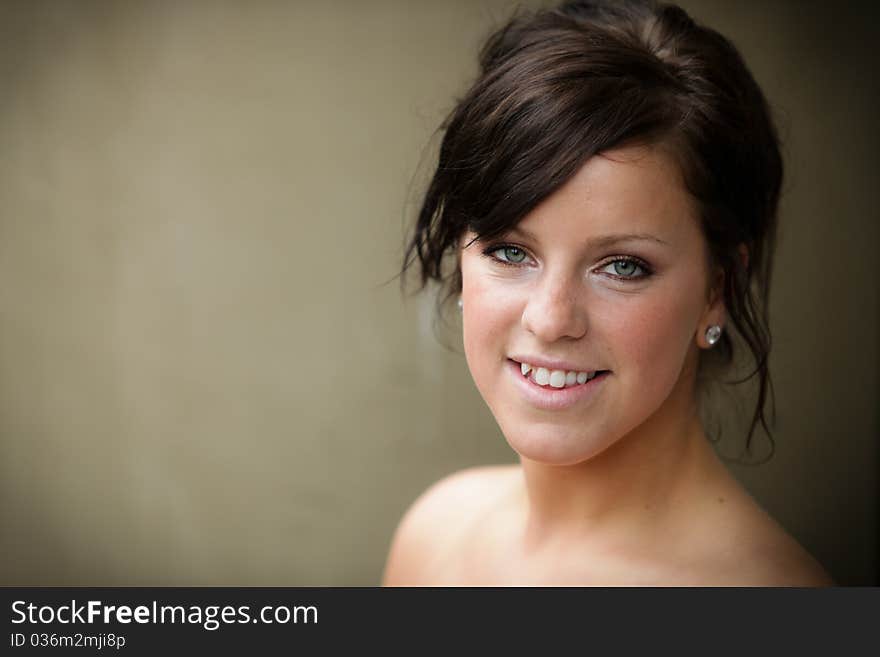 Head and shoulders of a woman against beige background. Head and shoulders of a woman against beige background