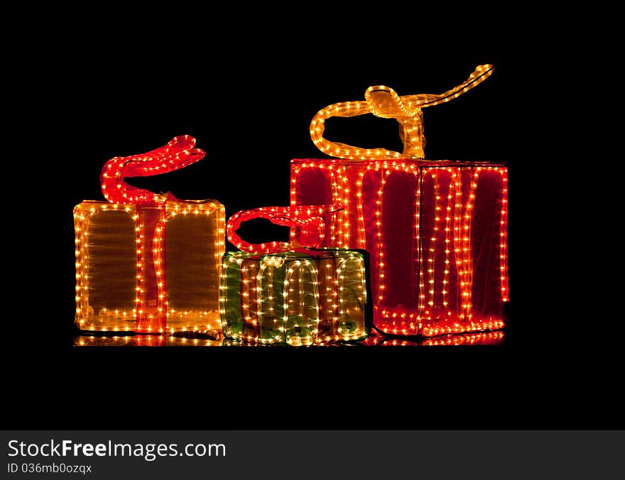 Unique decorative gift boxes made from christmas lights and chiffon on black background