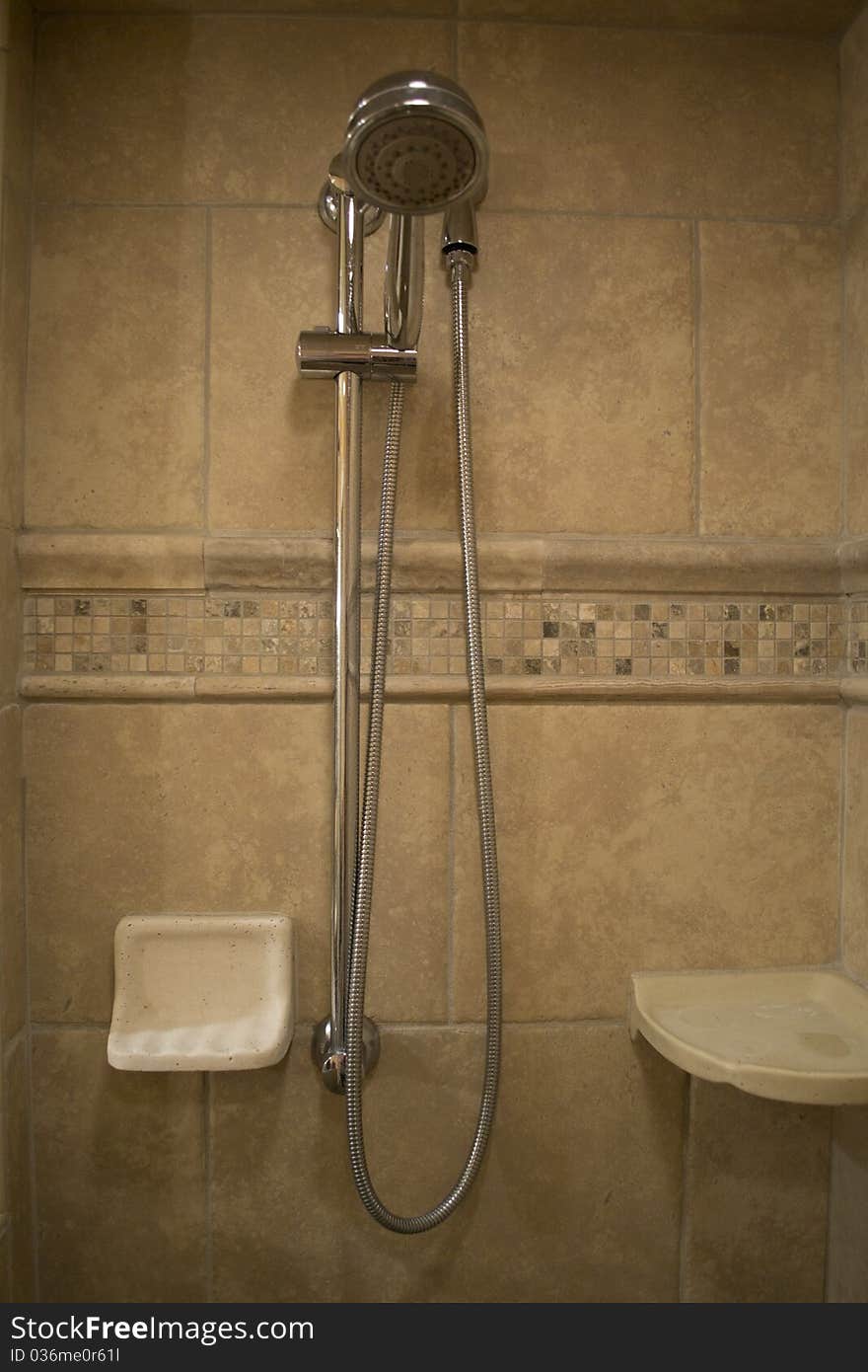 A Removable shower head in a walk-in shower.