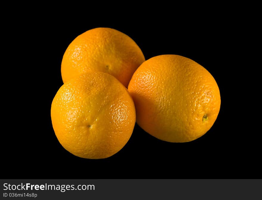 The Oranges in drop of water on black background. The Oranges in drop of water on black background.