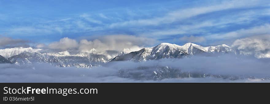 Clouds linger over the snow-capped Canadian Rockies in Southeastern British Columbia. Clouds linger over the snow-capped Canadian Rockies in Southeastern British Columbia.