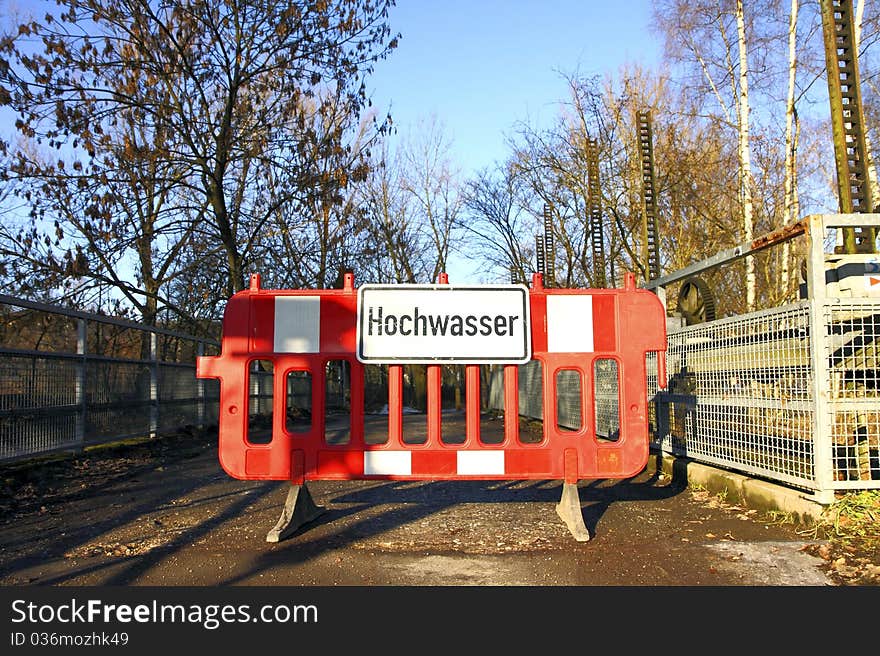 A barrier with a sign which refers floodwater