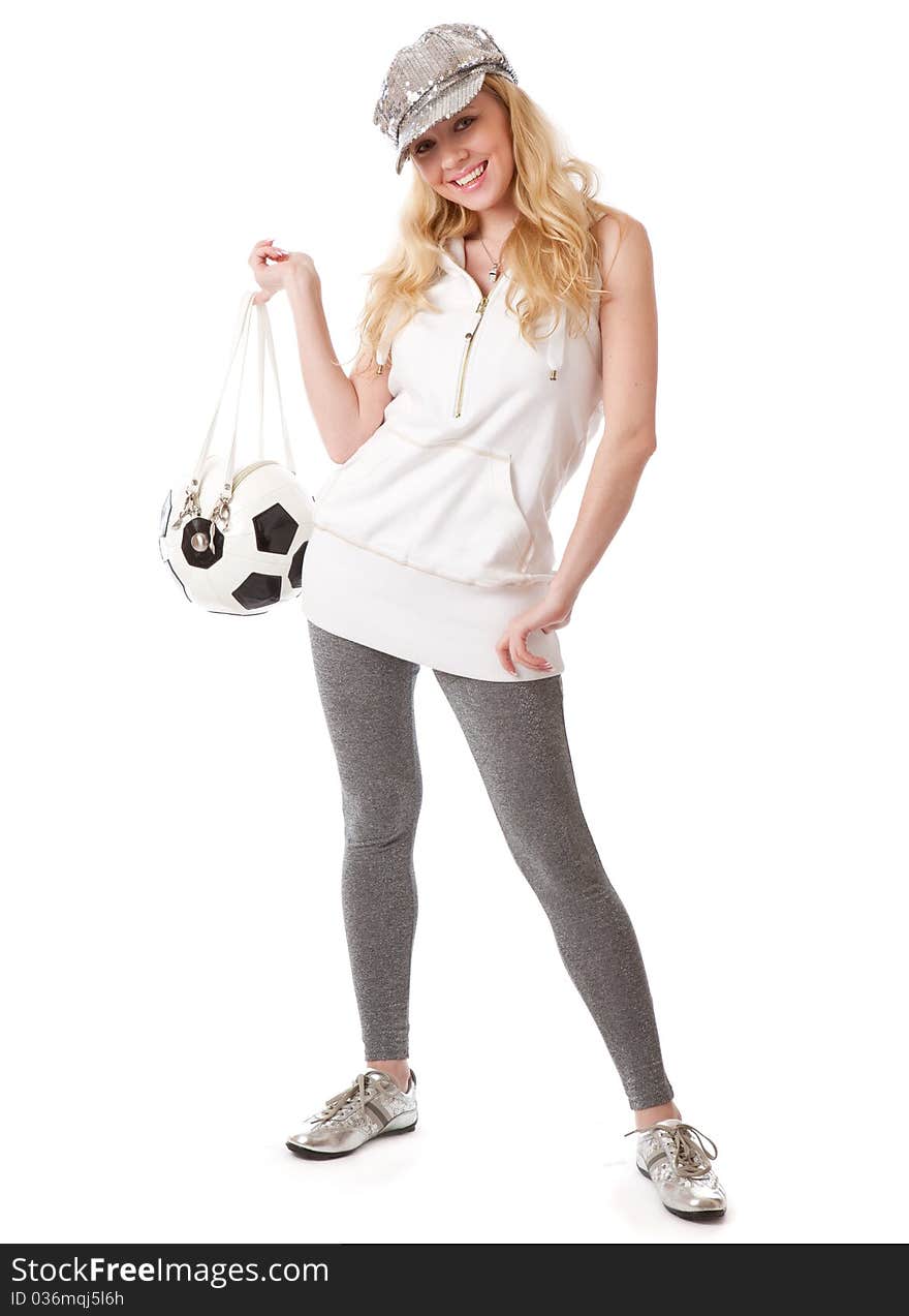 A smiling girl in a cap with a football ball