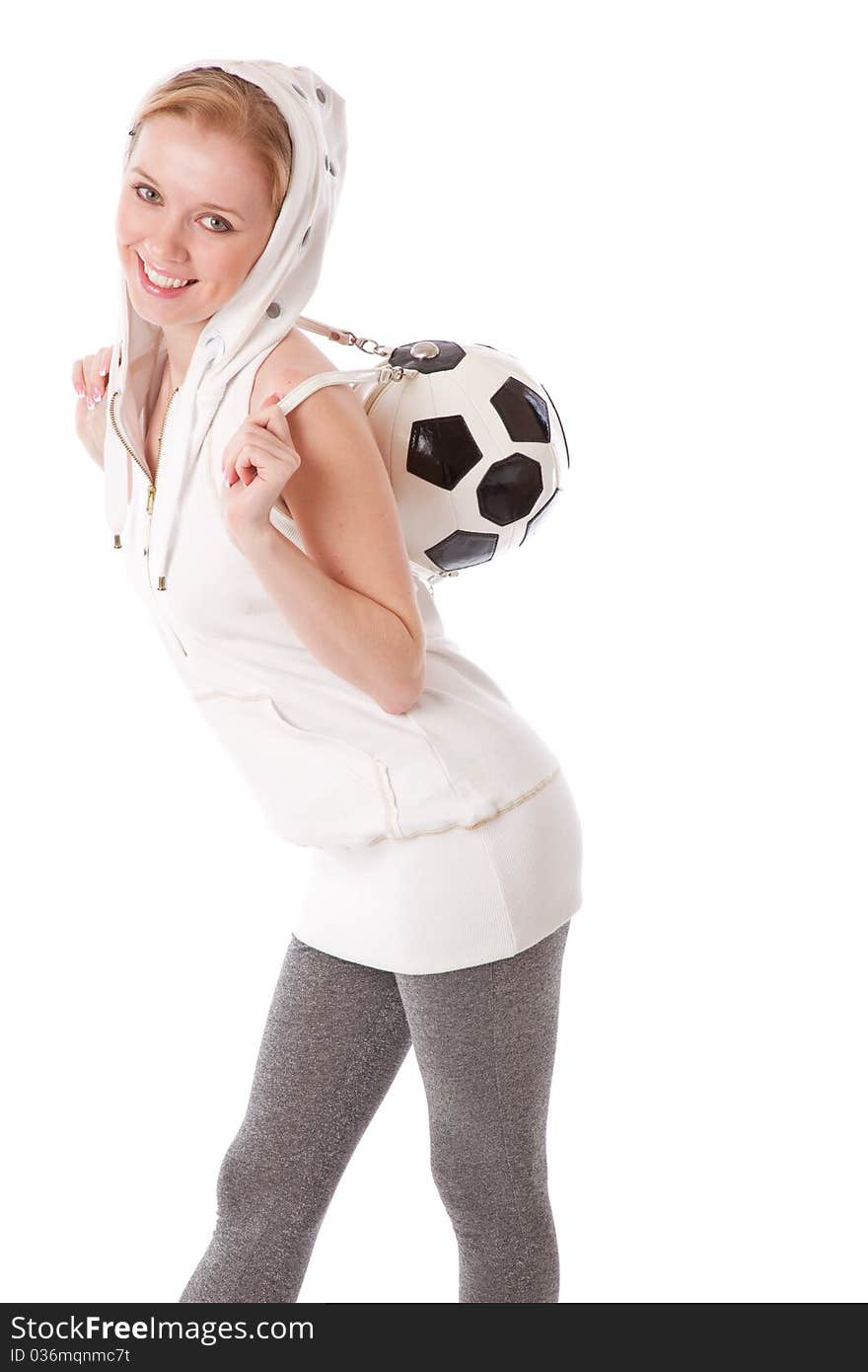 A smiling girl with a football ball on her back