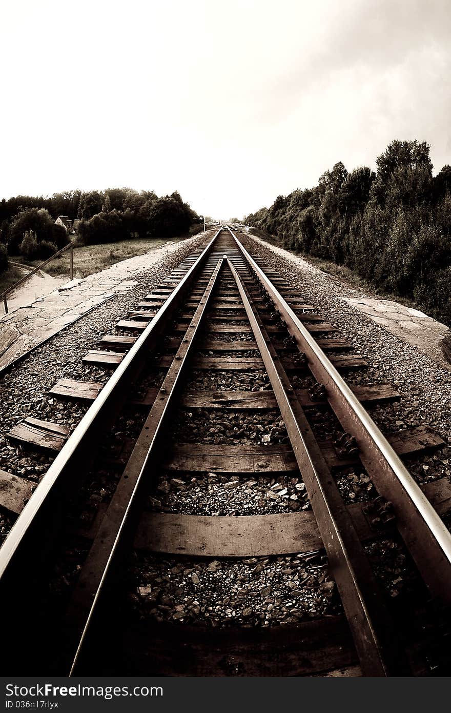 A long railway in the middle of the country, fisheye photo. A long railway in the middle of the country, fisheye photo.